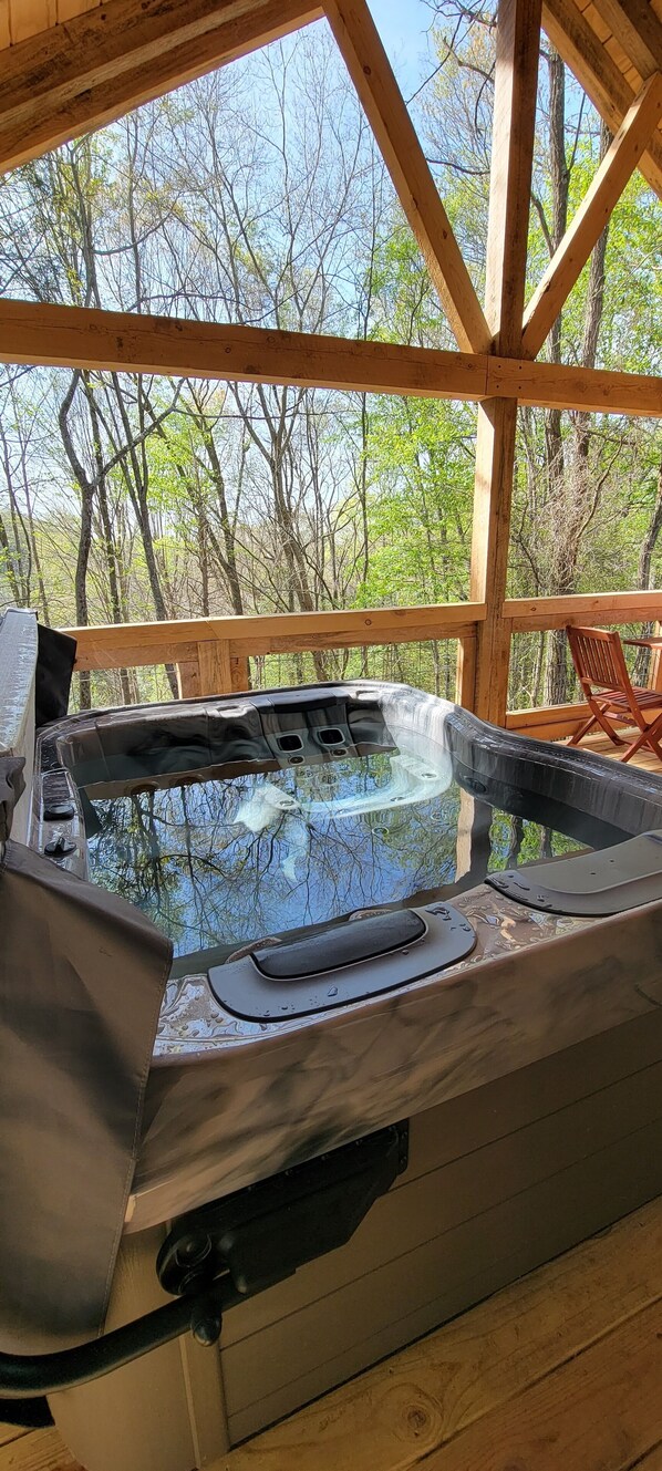 Premium bullfrog hot tub with a woodland view