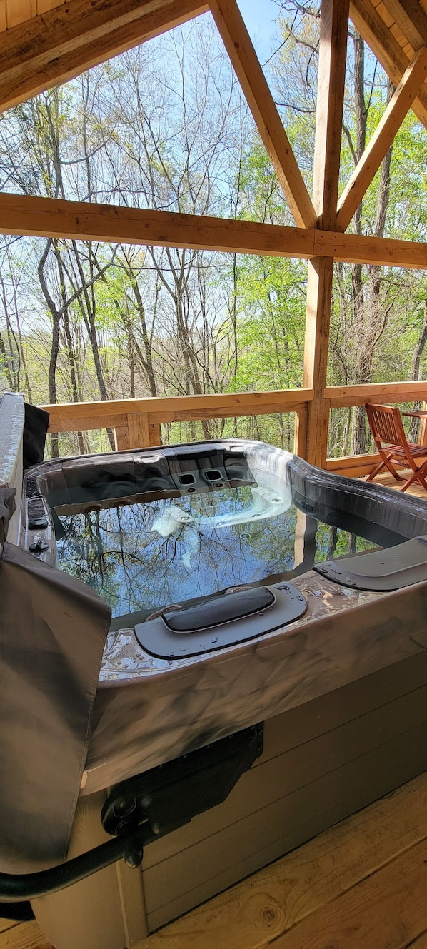 Premium bullfrog hot tub with a woodland view