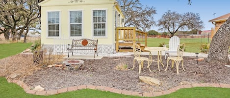 Freestanding cottage with outdoor seating areas.