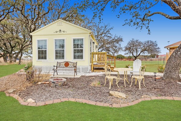 Freestanding cottage with outdoor seating areas.