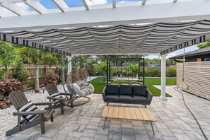 This outdoor pergola with incredible seating just might be the best spot for your morning cup of coffee...