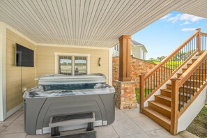 Relax in the hot tub while catching up on your latest show on the outdoor tv!