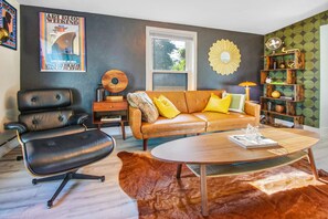 Jazzy, mid century modern, cozy, and the sofa is actually a sleeper futon 
