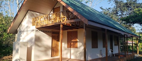 Backside of the house with outdoor shower on bottom left. Private balcony up top