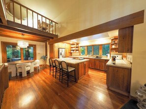 Relax at the kitchen island or breakfast nook, with easy access to the sunroom.