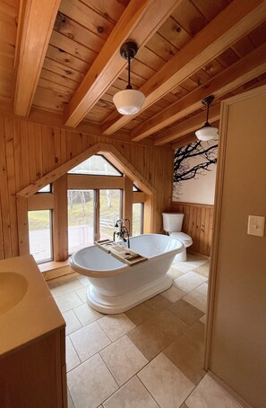 Indulge in the ensuite bathroom with a relaxing soak in the spacious tub.