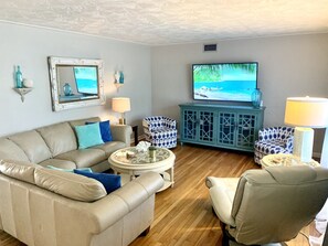 Living Room w/ leather sectional, recliner, and 65" smart TV