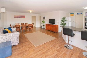 Family room with smart TV and open plan with kitchen and dining area