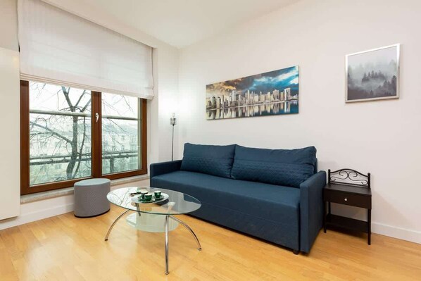 Relax in the stylish living room with a comfortable sofa and modern decor.