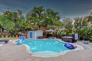 Resort-style living!  Beautiful heated pool, hot tub, putting green, multi-use sport area, and fire pit all on 2 acres of privacy in Hill Country