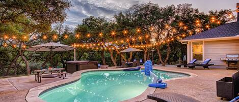 Resort-style living!  Beautiful heated pool, hot tub, putting green, multi-use sport area, and fire pit all on 2 acres of privacy in Hill Country