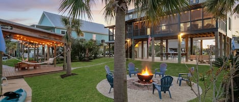 As the sun sets, the backyard transforms into a serene haven. Picture yourself by the water's edge, kayaking under the stars, swaying gently in the hammocks, sharing stories by the fire, and dining under the twinkle lights.
