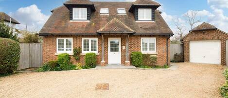 The front of the seaside home, with a large enough drive for 2/3 cars.