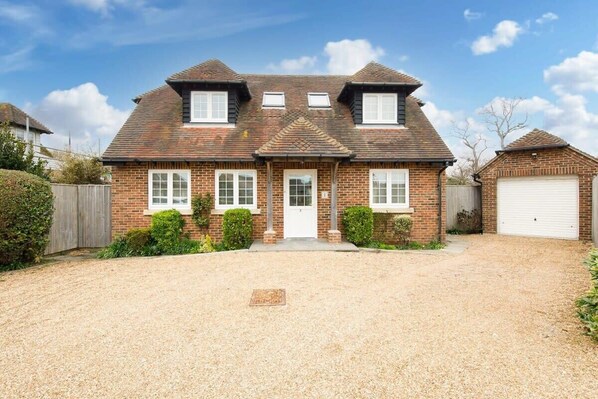 The front of the seaside home, with a large enough drive for 2/3 cars.