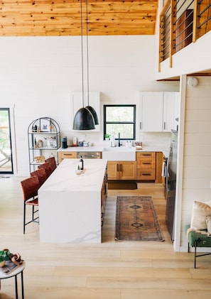 The expansive kitchen area is perfect for conversation, snacking, and booking your favorite meals.