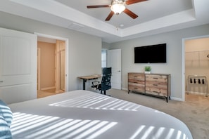 Beautiful bedroom with king bed, memory foam mattress, standing desk, and 55" Roku TV. Ensuite bathroom and 2 walk-in closets