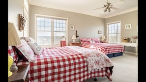 Spacious bedroom with a King and a Queen bed with bright seasonal bedding.