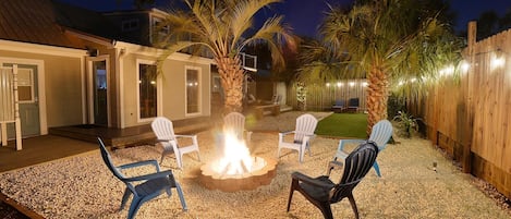 Enjoy the outdoor firepit and string lights around the yard. 