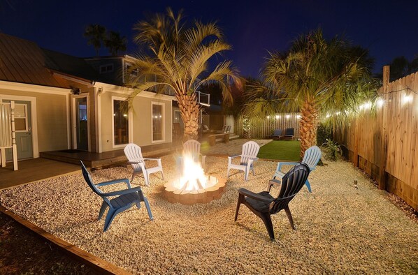 Enjoy the outdoor firepit and string lights around the yard. 