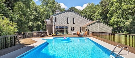 Enjoy a large fenced-in heated pool with a diving board and plenty of outdoor seating!