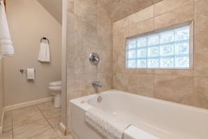 Indulge in our full bathroom with a bathtub, overhead shower, and mirror.
