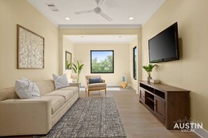 Upstairs living room with sleeper sofa, tv and yoga essentials