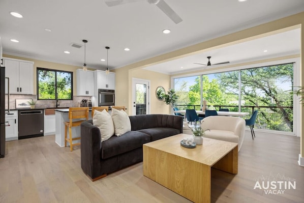 Large living area with open kitchen, living room, and dining room space