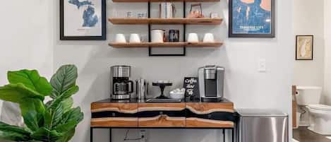 A fully loaded coffee bar includes: K cups, grounds, sugar, stevia, and creamers
