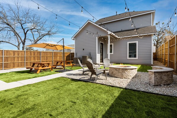 Cozy up next to the fire pit featured in the spacious backyard! 