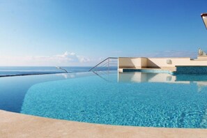 Laze away all day in the infinity pool with jacuzzi area