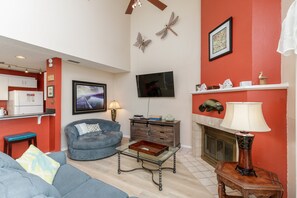 Open concept living area with flat screen TV and cozy furniture