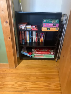 Games, puzzles and books located in the main floor bedroom.
