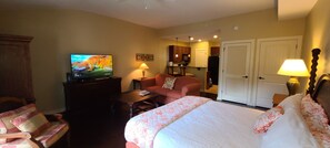 Bed to Sitting Area with TV and Kitchen