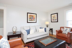 Living room with full sofa and chairs.