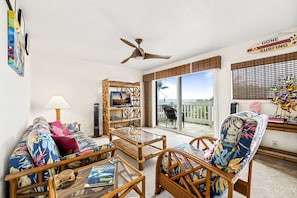 Tropically appointed living room with views of the neighboring beach