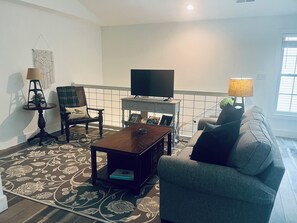 Living room with smart tv and new sofa with sofa bed.