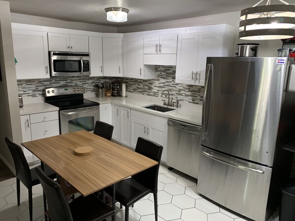 Full kitchen with dishwasher and large fridge. 