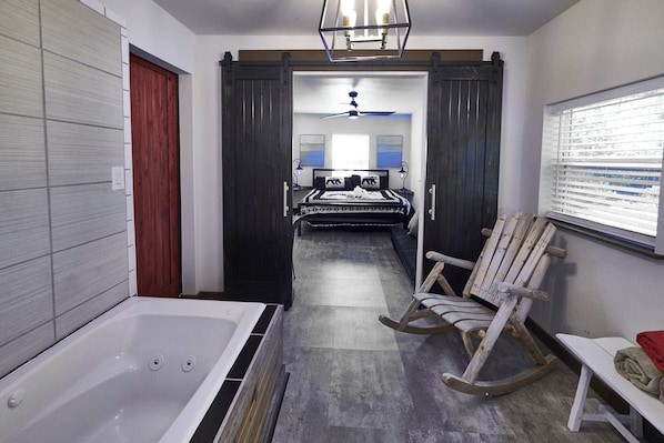 Sliding barn doors from the king bedroom lead to a stylish and sophisticated ensuite full bathroom