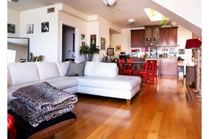 Open floor plan living room, dining room, half-bath, and kitchen