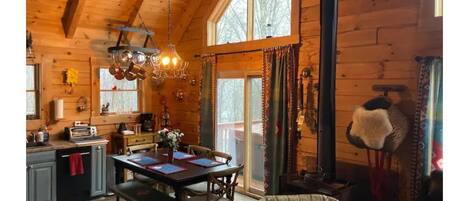 Dining and coffee station area, fireplace, outside sliding doors, is the hot tub