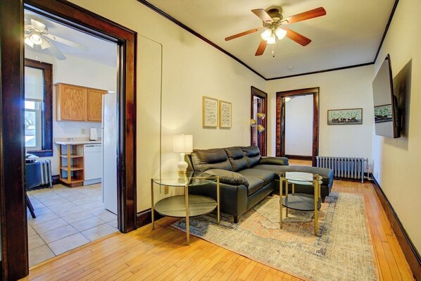 View of living room and kitchen with entertainment center and Roku TV