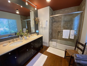 Luxury bathroom with double sinks and shower/tub combo.