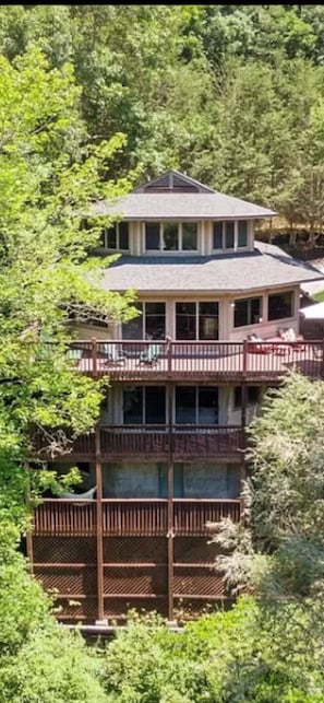 Back view of home showing all three large decks.