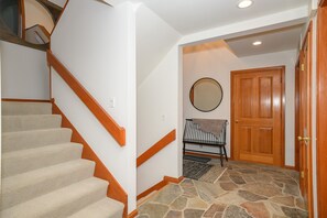 Entry area off of front door and garage, with coat closet and powder bath.