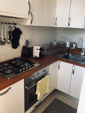 Kitchen with cooktop, oven, dishwasher, refrigerator/freezer, Nespresso, etc.