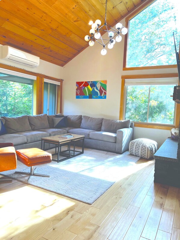 Open concept family room with lots of natural light from multiple windows.