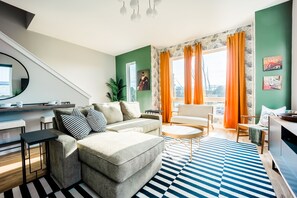 Naturally bright and open living area with smart TV.