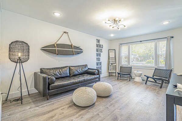 Living area with long leather couch.
