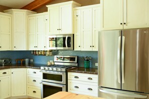 Stainless steel appliances and plenty of kitchen supplies.