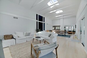 Family room with Samsung Frame TV, overlooking deck and bay.